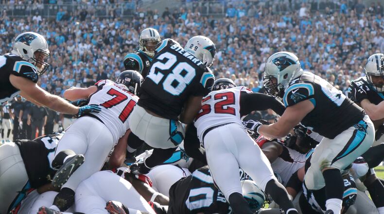 Carolina Panthers' Jonathan Stewart (28) dives into the end zone for a touchdown against the Atlanta Falcons in the first half of an NFL football game in Charlotte, N.C., Sunday, Dec. 13, 2015. (AP Photo/Chuck Burton)