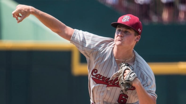 South Carolina pitcher Clarke Schmidt delivers to home plate against Oklahoma State during an NCAA college baseball tournament super regional game Sunday, June 12, 2016, in Columbia, S.C. Oklahoma State defeated South Carolina 3-1 to advance to the College World Series. (AP Photo/Sean Rayford)