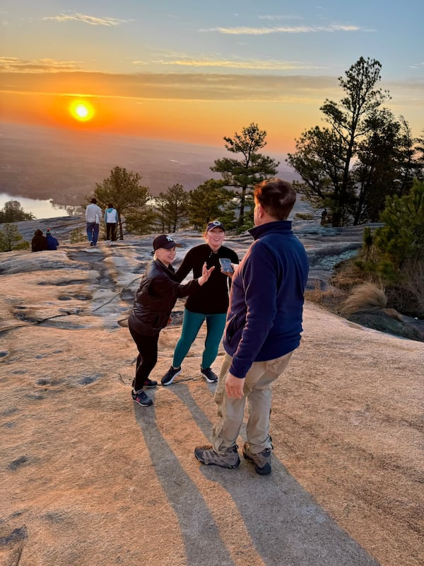 Emory Morsberger takes a photo of a family visiting Stone Mountain at sunrise. He has committed this random act of kindness 3,000 times. (Courtesy Emory Morsberger)
