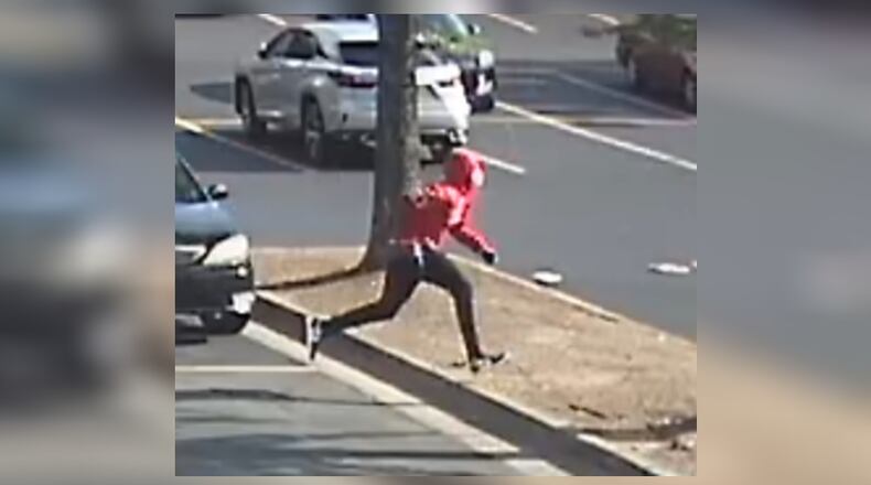 Police on Thursday released surveillance photos of a suspect wanted in a fatal double shooting last week at a Smyrna shopping center.