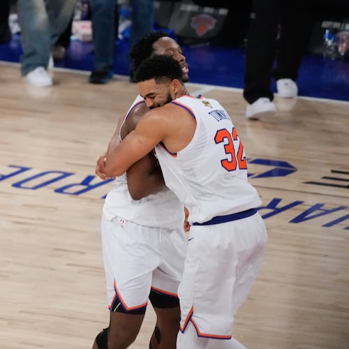 New York Knicks center Karl-Anthony Towns (32) embraces forward Og Anunoby after Game 4 of the NBA Finals basketball series against the San Antonio Spurs, Wednesday, June 10, 2026, in New York. (AP Photo/Ross D. Franklin)