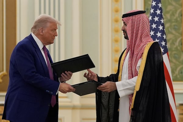 President Donald Trump and Saudi Crown Prince Mohammed bin Salman exchange documents during a signing ceremony at the Royal Palace, Tuesday, May 13, 2025. (AP Photo/Alex Brandon)