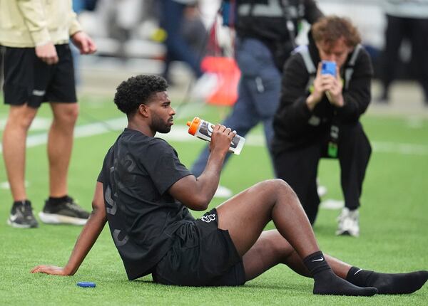 Colorado quarterback Shedeur Sanders pauses for a drink before taking part in passing drills during Colorado's NFL football pro day Friday, April 4, 2025, in Boulder, Colo. (AP Photo/David Zalubowski)