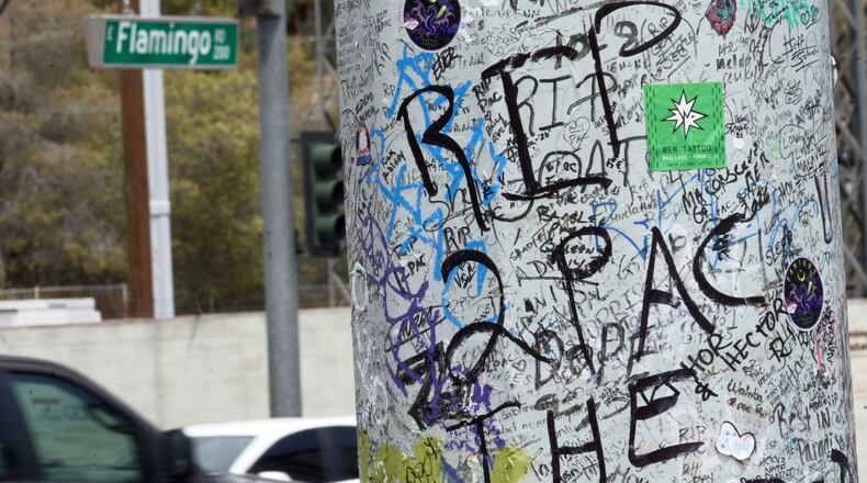 Graffiti about Tupac is seen on a pole Monday, Aug. 10, 2026, near the intersection where he was shot at in Las Vegas. (AP Photo/Ty ONeil)