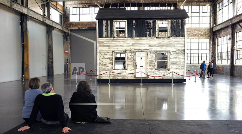 FILE - In this April 1, 2018 file photo, visitors view the rebuilt house of Rosa Parks at the WaterFire Arts Center in Providence, R.I. The house where Parks sought refuge in Detroit after fleeing the South will be auctioned on Thursday, July 26 in New York, with a minimum bid of $1 million. (AP Photo/Steven Senne, File)