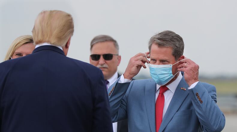 Georgia Gov. Brian Kemp, right, greets President Donald Trump as he visits Georgia to talk about an infrastructure overhaul at the UPS Hapeville hub at Hartsfield-Jackson International Airport in Atlanta on Wednesday, July 15, 2020. (Curtis Compton/Atlanta Journal-Constitution/TNS)