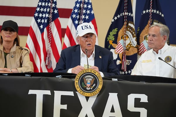 President Donald Trump speaks as first lady Melania Trump, left, and Texas Gov. Greg Abbott listen during a roundtable discussion with first responders and local officials at Hill Country Youth Event Center in Kerrville, Texas, during a tour to observe flood damage, Friday, July 11, 2025. (AP Photo/Jacquelyn Martin)