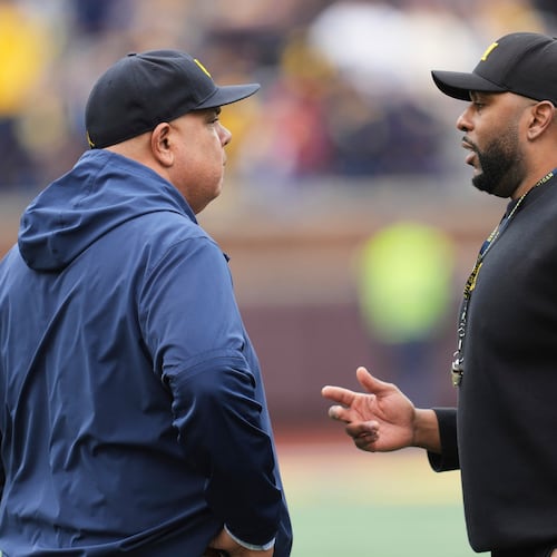 FILE - Michigan athletic director Warde Manuel, left, talks with head coach Sherrone Moore, right, before an NCAA college football spring game in Ann Arbor, Mich., April 19, 2025. (AP Photo/Paul Sancya, file)