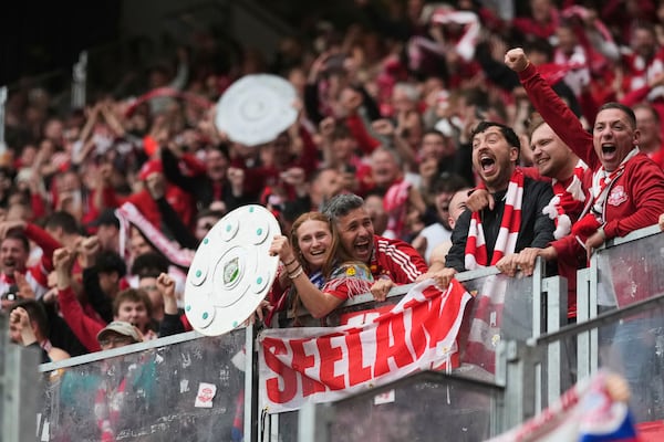 Bayern fans celebrate after Bayern's Leroy Sane scored his side's third goal during the German Bundesliga soccer match between RB Leipzig and FC Bayern Munich at the Red Bull Arena in Leipzig, Germany, Saturday, May 3, 2025. (AP Photo/Matthias Schrader)