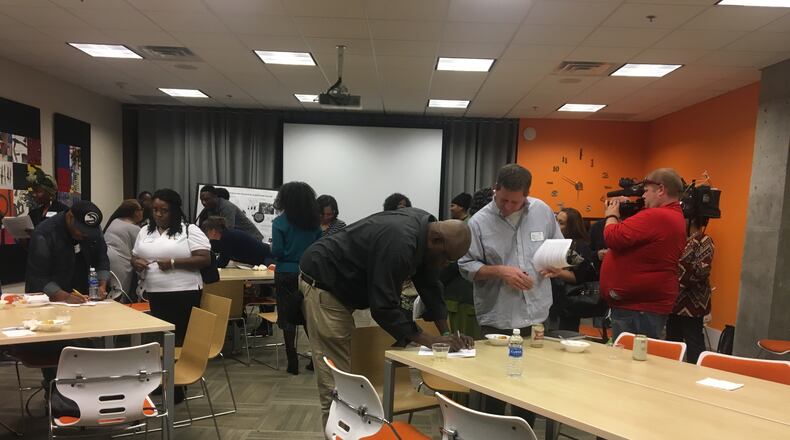 Guests at Urban Media Makers' “Come Meet a Black Person” mixer fill out “cultural scavenger hunts.”