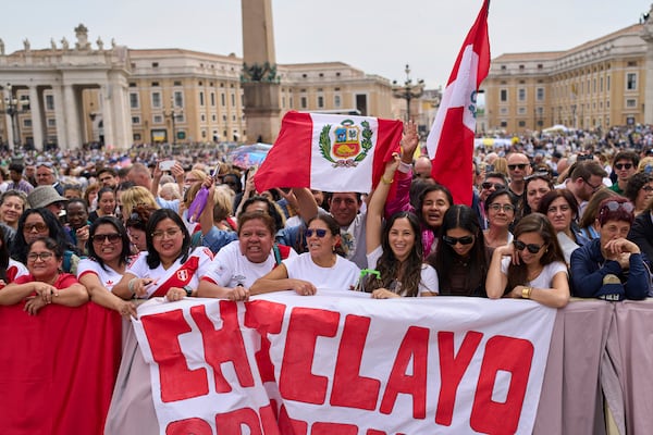 Faithful from Chiclayo, Peru, wave flags and react as Pope Leo XIV appears at the central balcony of St. Peter's Basilica for his first Sunday blessing after his election, in St. Peter's Square at the Vatican, Sunday, May 11, 2025.(AP Photo/Bernat Armangue)