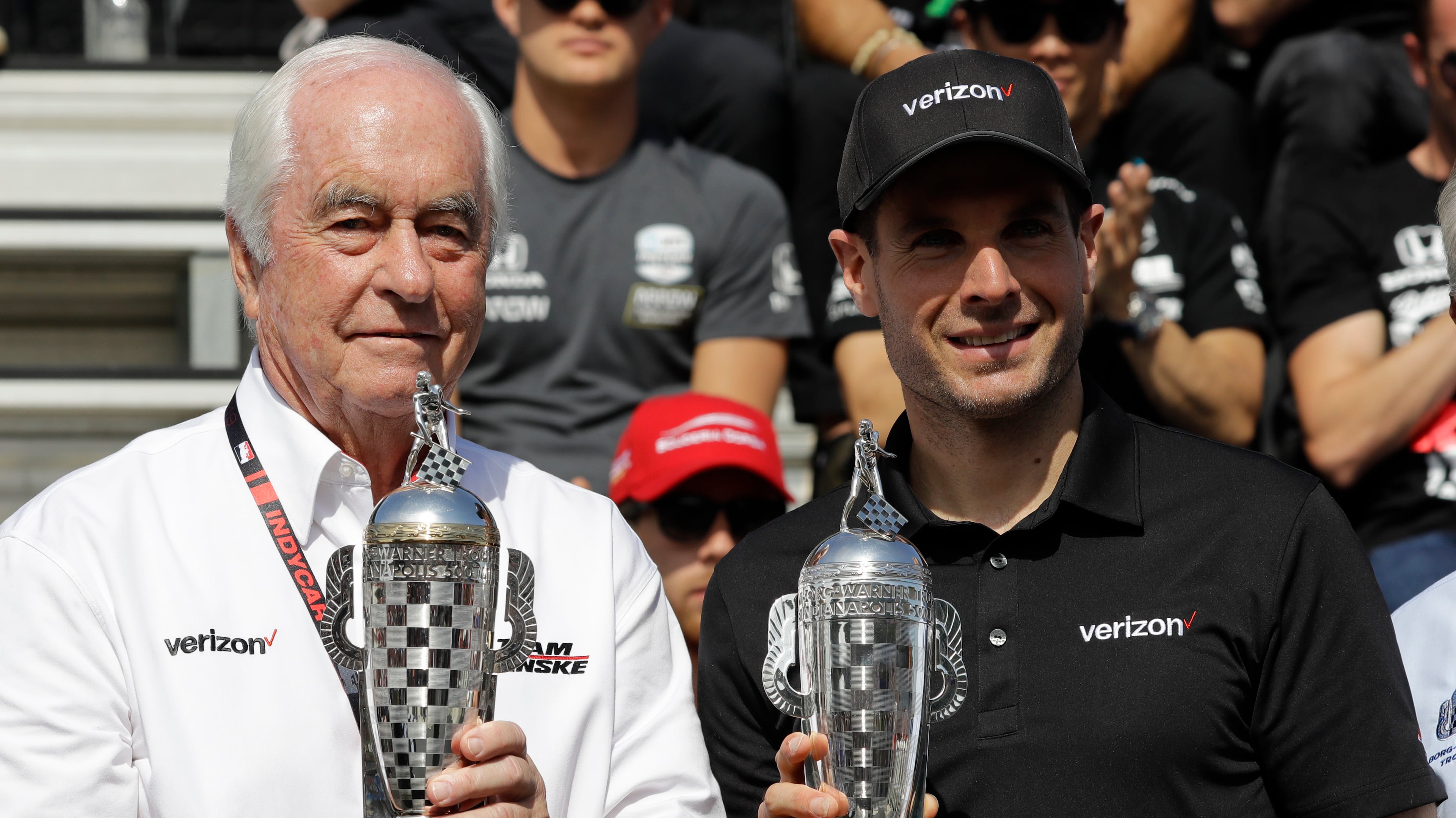 FILE - Car owner Roger Penske, left, and driver Will Power, of Australia, receive their "Baby Borg" trophies for winning last years race during the drivers meeting for the Indianapolis 500 IndyCar auto race at Indianapolis Motor Speedway, Saturday, May 25, 2019, in Indianapolis. (AP Photo/Darron Cummings, file)