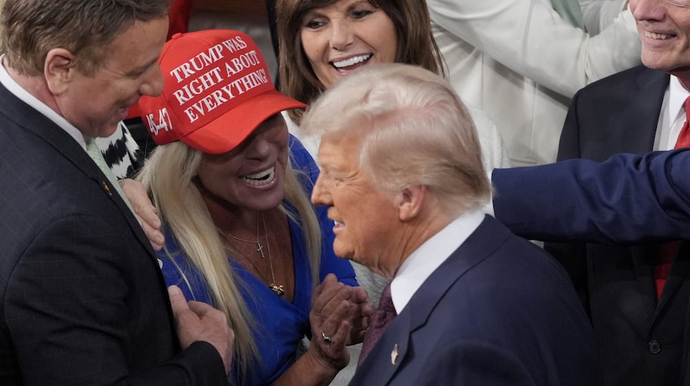 President Donald Trump walks by U.S. Rep. Marjorie Taylor Greene, R-Ga., to address a joint session of Congress at the Capitol in Washington on Tuesday, March 4, 2025. (J. Scott Applewhite/AP 2025)