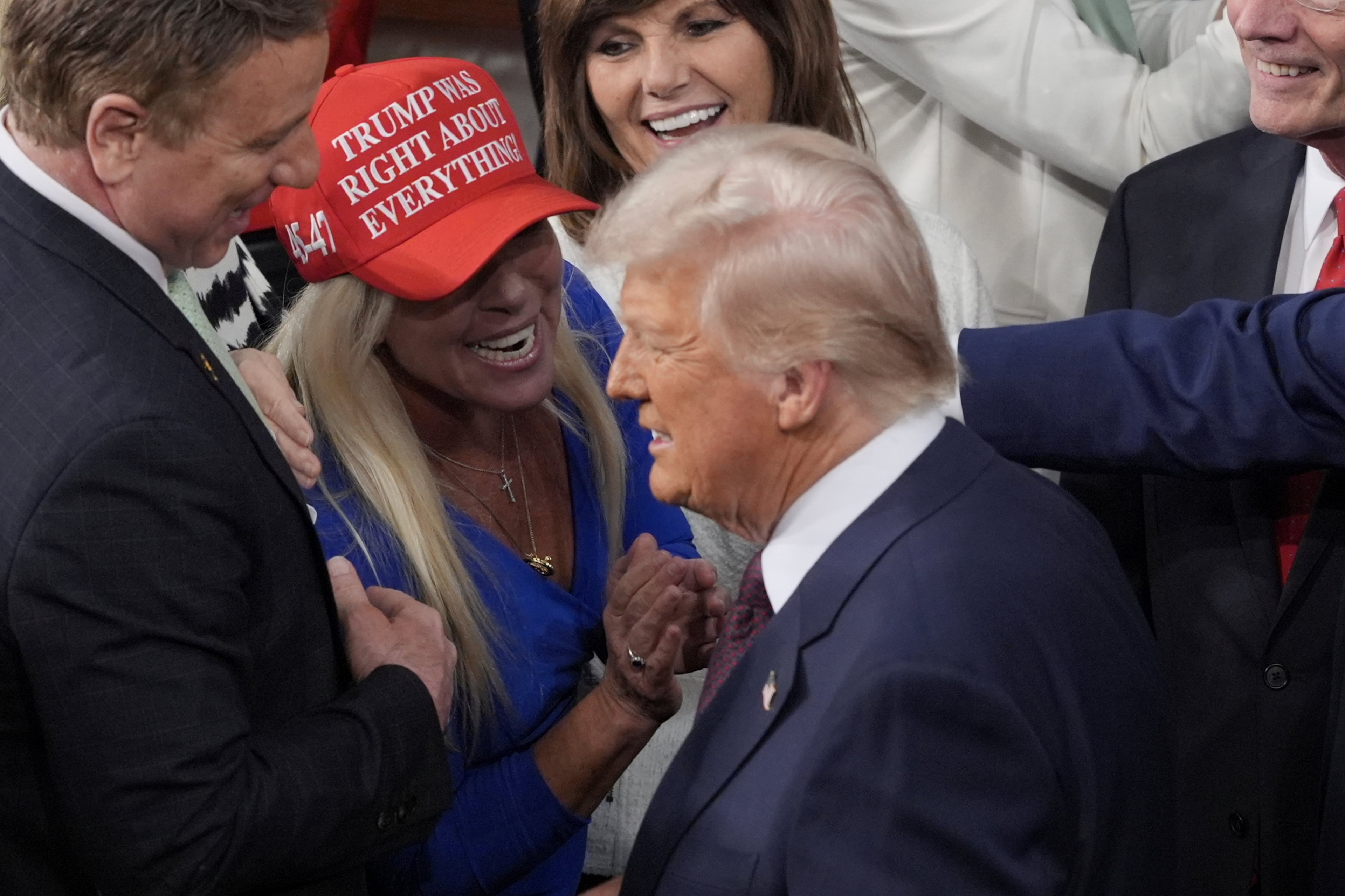 President Donald Trump passes by Rep. Marjorie Taylor Greene to address a joint session of Congress at the Capitol in Washington, Tuesday, March 4, 2025. Greene is wearing a "Trump was right about everything" hat; at the time the two were close. (J. Scott Applewhite/AP)