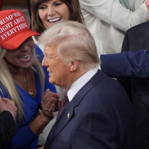 FILE - President Donald Trump arrives and walks by Rep. Marjorie Taylor Greene, R-Ga., to address a joint session of Congress at the Capitol in Washington, Tuesday, March 4, 2025. (AP Photo/J. Scott Applewhite, File)