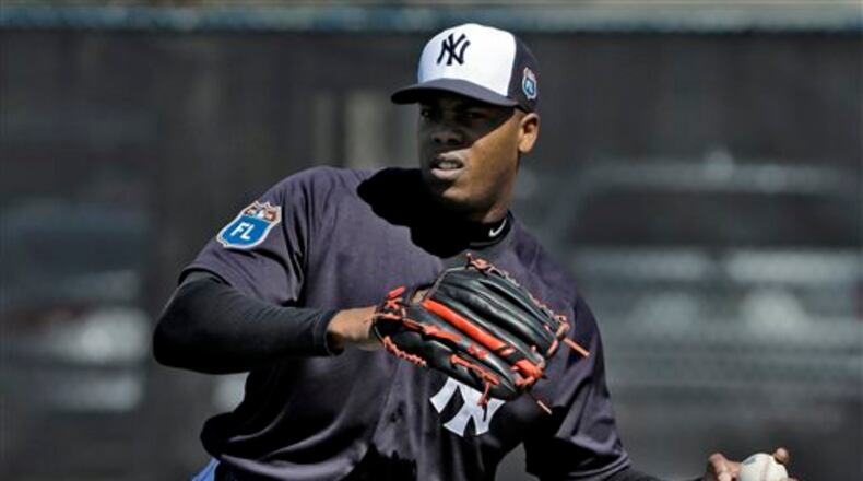 FILE - In this Feb. 19, 2016, file photo, New York Yankees pitcher Aroldis Chapman throws a ball during a spring training baseball workout in Tampa, Fla. A day after accepting a 30-game suspension, Chapman apologized Wednesday, March 2, 2016, for using a gun and insisted he never hurt his girlfriend. Chapman agreed to the penalty, assessed by Major League Baseball under its new domestic violence policy. (AP Photo/Chris O'Meara, File)