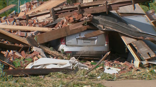 Debris covers the ground and a vehicle after a severe storm passed the area on Saturday, May 17, 2025 in St. Louis, Mo. ( KMOV via AP)