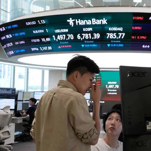 Currency traders work at the foreign exchange dealing room of the Hana Bank headquarters in Seoul, South Korea, Tuesday, July 14, 2026. (AP Photo/Ahn Young-joon)