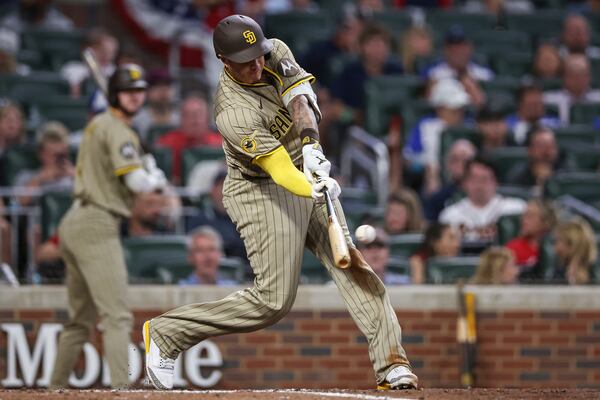 San Diego Padres' Manny Machado hits a home run in the ninth inning of a baseball game against the Atlanta Braves, Friday, May 23, 2025, in Atlanta. (AP Photo/Colin Hubbard)