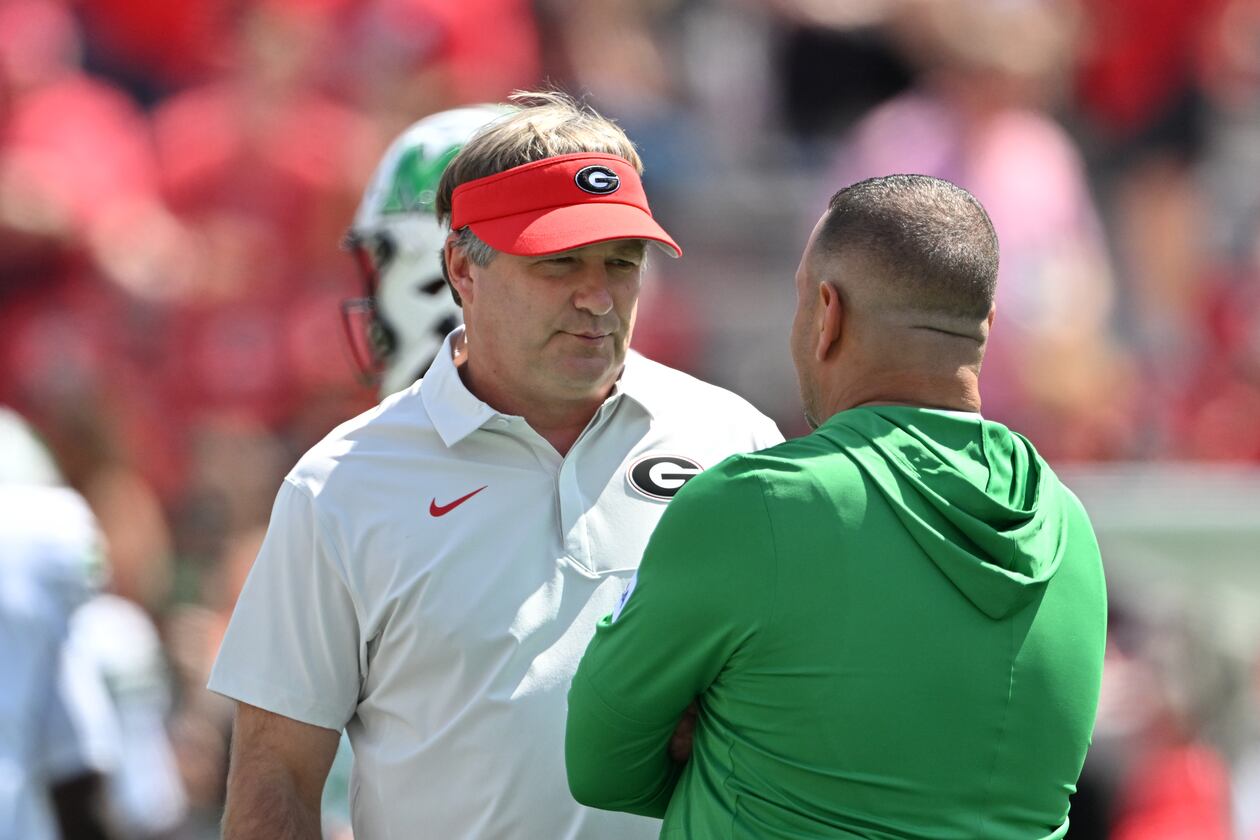 Georgia head coach Kirby Smart (left) speaks with Marshall head coach Tony Gibson at Sanford Stadium on Saturday, Aug. 30, 2025, in Athens. Smart was not happy with the level of competition Marshall provided in last season’s opening game. (Hyosub Shin/AJC)