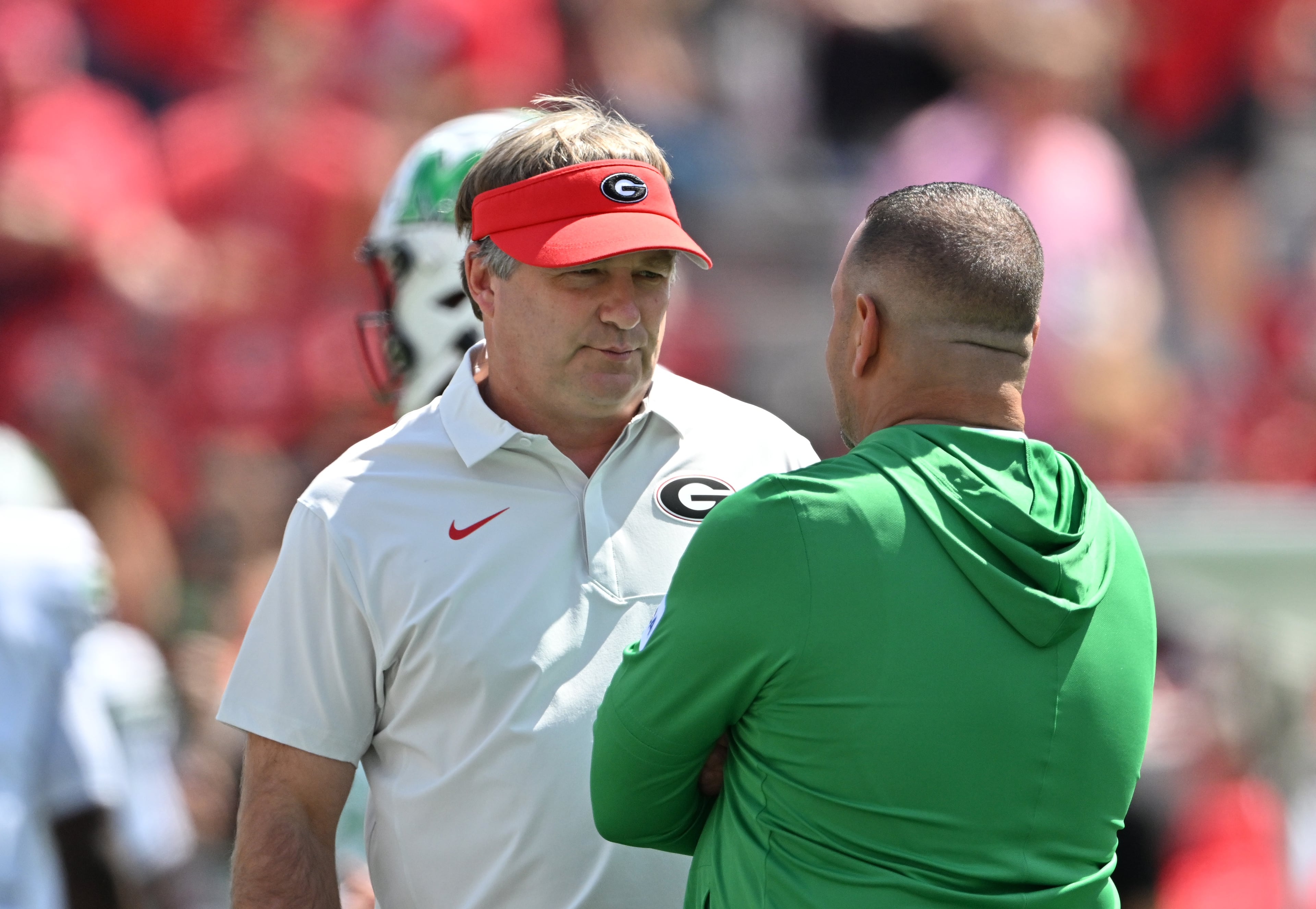 Georgia head coach Kirby Smart talks with Marshall head coach Tony Gibson before Georgia football's season opener and home opener against Marshall at Sanford Stadium, Saturday, August 30, 2025, in Athens. (Hyosub Shin / AJC)