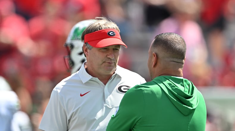 Georgia head coach Kirby Smart (left) speaks with Marshall head coach Tony Gibson at Sanford Stadium on Saturday, Aug. 30, 2025, in Athens. Smart was not happy with the level of competition Marshall provided in last season’s opening game. (Hyosub Shin/AJC)