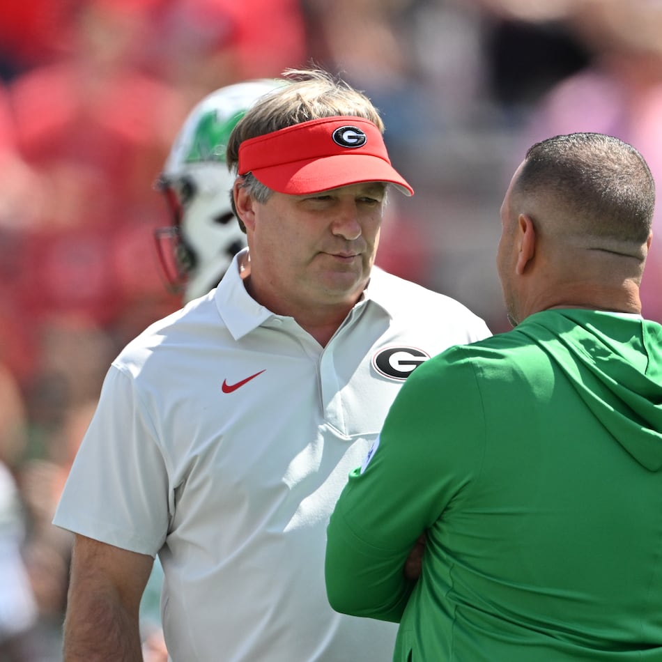 Georgia head coach Kirby Smart (left) speaks with Marshall head coach Tony Gibson at Sanford Stadium on Saturday, Aug. 30, 2025, in Athens. Smart was not happy with the level of competition Marshall provided in last season’s opening game. (Hyosub Shin/AJC)