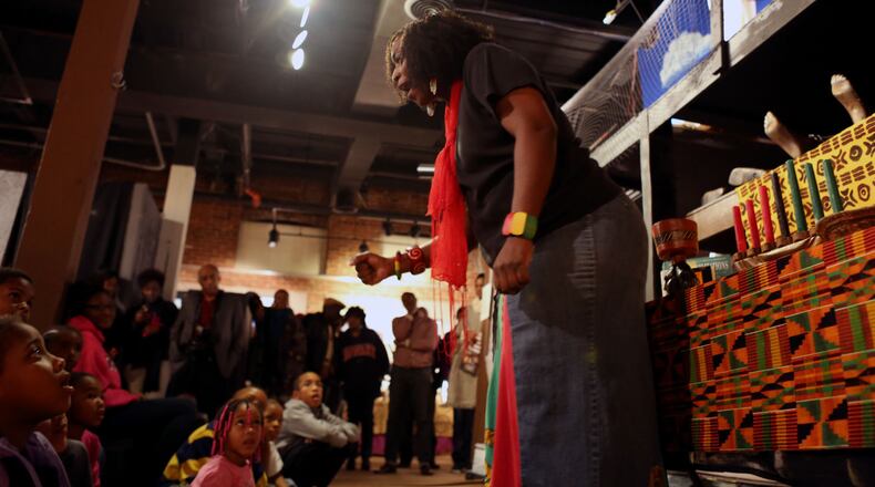 A storyteller entertains the children as a part of Kwanzaa activities at the APEX Museum. (Akili-Casundria Ramsess/Special to the AJC)