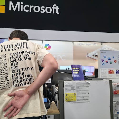 FILE - Middle school teacher Jeremy Hook shops for the latests Microsoft's Surface Laptop Copilot+ PC's at Best Buy Atwater Village store in Glendale, Calif., Tuesday, July 29, 2025. (AP Photo/Damian Dovarganes, File)