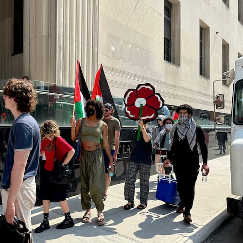 People carry Palestinian flags outside the federal courthouse in Detroit on Wednesday, June 10, 2026, after activists appeared in court on conspiracy charges. (AP Photo/Ed White)