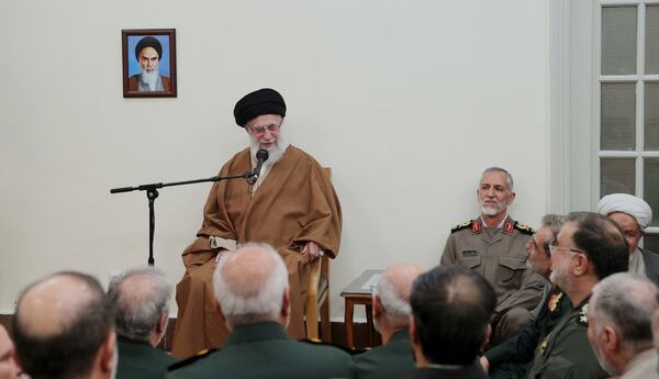 In this photo released by the official website of the office of the Iranian supreme leader, Supreme Leader Ayatollah Ali Khamenei speaks in a meeting with a group of armed forces commanders, in Tehran, Iran, Sunday, April 13, 2025. A portrait of the late revolutionary founder Ayatollah Khomeini hangs on the wall. (Office of the Iranian Supreme Leader via AP)