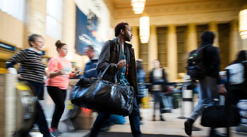 Travelers make their way through the 30th Street Station ahead of the Thanksgiving Day holiday, in Philadelphia, Tuesday, Nov. 22, 2016. Almost 49 million people are expected to travel 50 miles or more for the holiday, the most since 2007, according to AAA. (AP Photo/Matt Rourke)