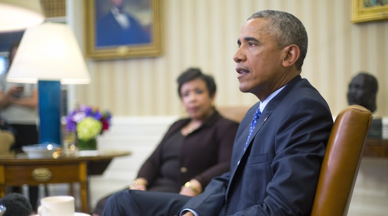 President Obama speaks about using executive power, this time related to gun control, as Attorney General Loretta Lynch listens. Not pictured: Donald Trump. (AP Photo / Pablo Martinez Monsivais)