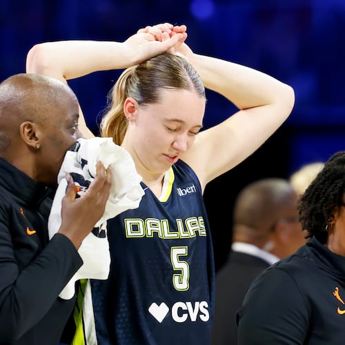 Dallas Wings guard Paige Bueckers (5) holds her head after a collision with Los Angeles Sparks forward Nneka Ogwumike during the second half of a WNBA basketball game, Sunday, July 19, 2026, in Arlington, Texas. (Elías Valverde II/The Dallas Morning News via AP)