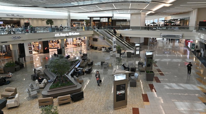 International travelers rest at the Autrium in Atlanta's Maynard H. Jackson Jr. International Terminal on Friday, April 29, 2022. (Hyosub Shin / Hyosub.Shin@ajc.com)