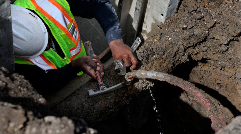 Blackhawk Sewer & Water contractor Khalid Waarith fixes a leaking lead service pipe ahead of service line replacement on the 3100 block of South Ridgeway Avenue in Chicago on April 10, 2023. (Antonio Perez/Chicago Tribune/TNS)