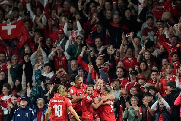 Switzerland's Geraldine Reuteler celebrates with team mates after scoring the opening goal during the Euro 2025, group A, soccer match between Switzerland and Iceland at Stadion Wankdorf in Bern, Switzerland, Sunday, July 6, 2025. (AP Photo/Martin Meissner)