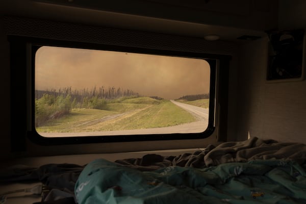 Wildfire smoke hangs in the air above Highway 97 north of Buckinghorse River, British Columbia, on Friday, May 30, 2025. (Nasuna Stuart-Ulin/The Canadian Press via AP)