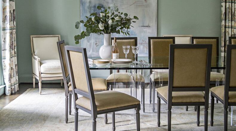 Bosbyshell designed this traditional-with-a-twist dining room, located in the Argonne Forrest neighborhood in Buckhead, for a young family of seven. The Lucite table is mixed with traditional chairs and an Oushak rug. Contributed by Heidi Gelhauser