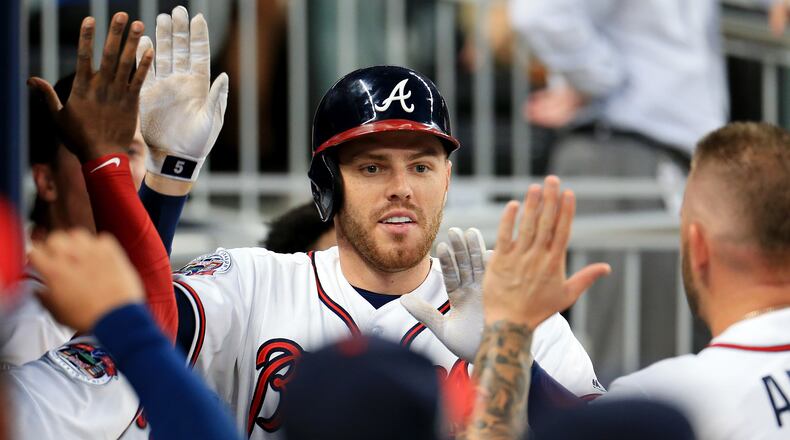 Hot-hitting first baseman Freddie Freeman was out of the Braves lineup Saturday due to a stomach virus.