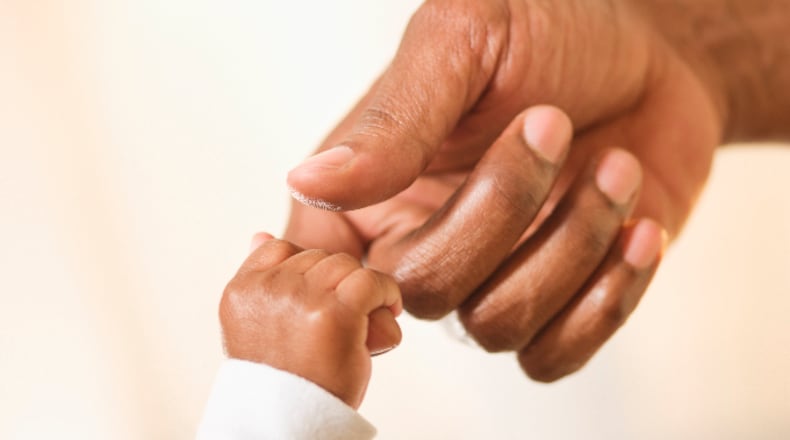 Baby grabbing mother's finger (Camille Tokerud / The Image Bank / Getty Images)