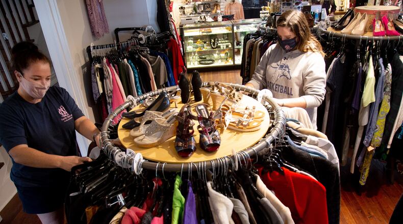 National Charity League volunteers Hilary Aslaksen and her daughter Rory Hansen sort through clothes at the Giving Tree Thrift store Chamblee Saturday, October 24, 2020.   STEVE SCHAEFER / SPECIAL TO THE AJC
