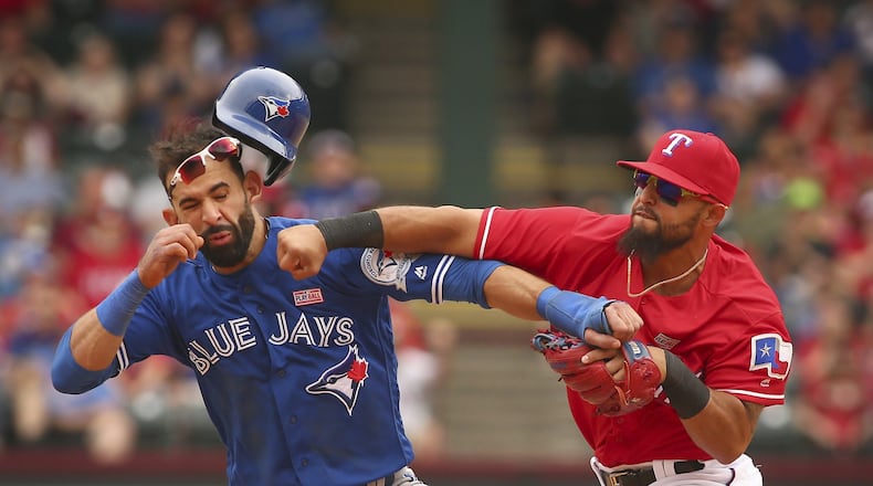 After Jose Bautista caused a benches-clearing incident Wednesday with a bat flip after a homer with his team down five runs, Braves pitcher Eric O’Flaherty referenced this famous punch that Bautista (left) took from Rangers second baseman Rougned Odor in May 2016. (AP file photo)