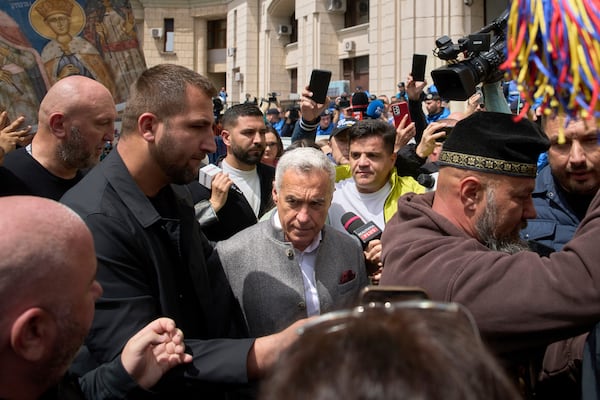 Calin Georgescu, the winner of the first round of last year's annulled election, leaves a prosecutor's office in Bucharest, Romania, Tuesday, May 27, 2025. (AP Photo/Vadim Ghirda)