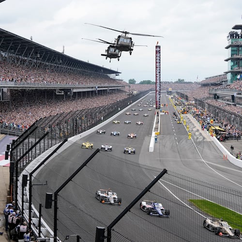 FILE - Helicopters fly over the field on the parade lap before the Indianapolis 500 auto race in Indianapolis, May 24, 2026. (AP Photo/Michael Conroy, File)
