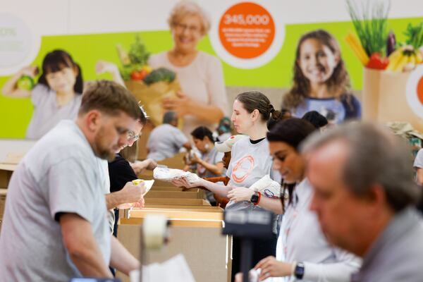 Lawyers and other participants in the Georgia Legal Food Frenzy sort food donations at the Atlanta Community Food Bank in Atlanta on April 17, 2026. (Arvin Temkar/AJC)