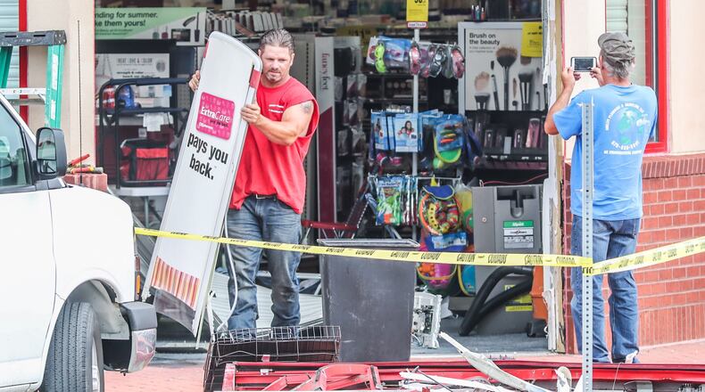 Crews survey the damage outside a northwest Atlanta CVS on Monday.