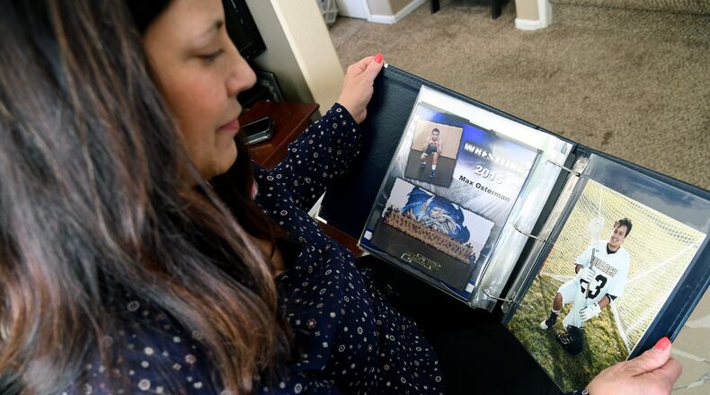 Kim Osterman shows photos of her son Max, who she says died after taking fentanyl he bought from a dealer on Snapchat, in her living room in Thornton, Colo., on Thursday, March 26, 2026. (AP Photo/Thomas Peipert)