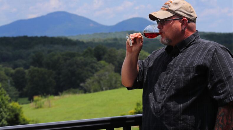 Local resident James Redden, 45, takes in the view of the Appalachian Mountains while tasting wine on the back porch at Kaya Vineyard & Winery in Dahlonega.