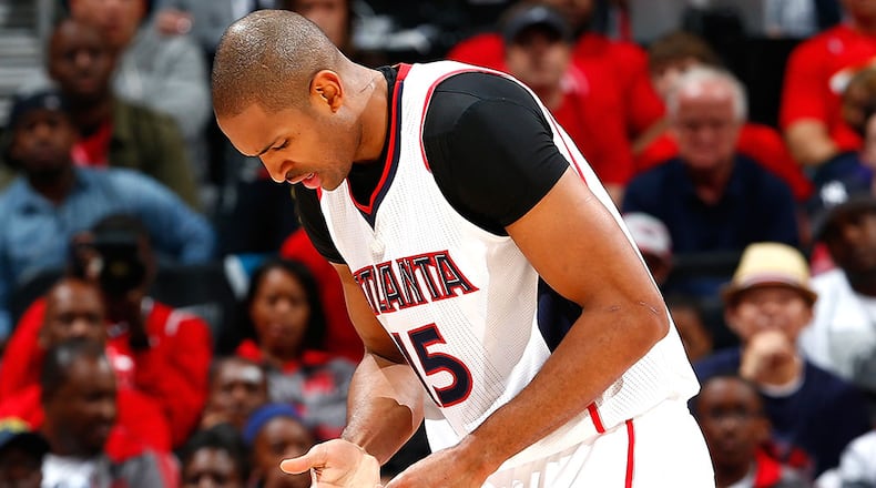 Hawks forward Al Horford holds his hand after he dislocated his right pinky finger against the Nets in Game 1 of their playoff series Sunday in Atlanta.